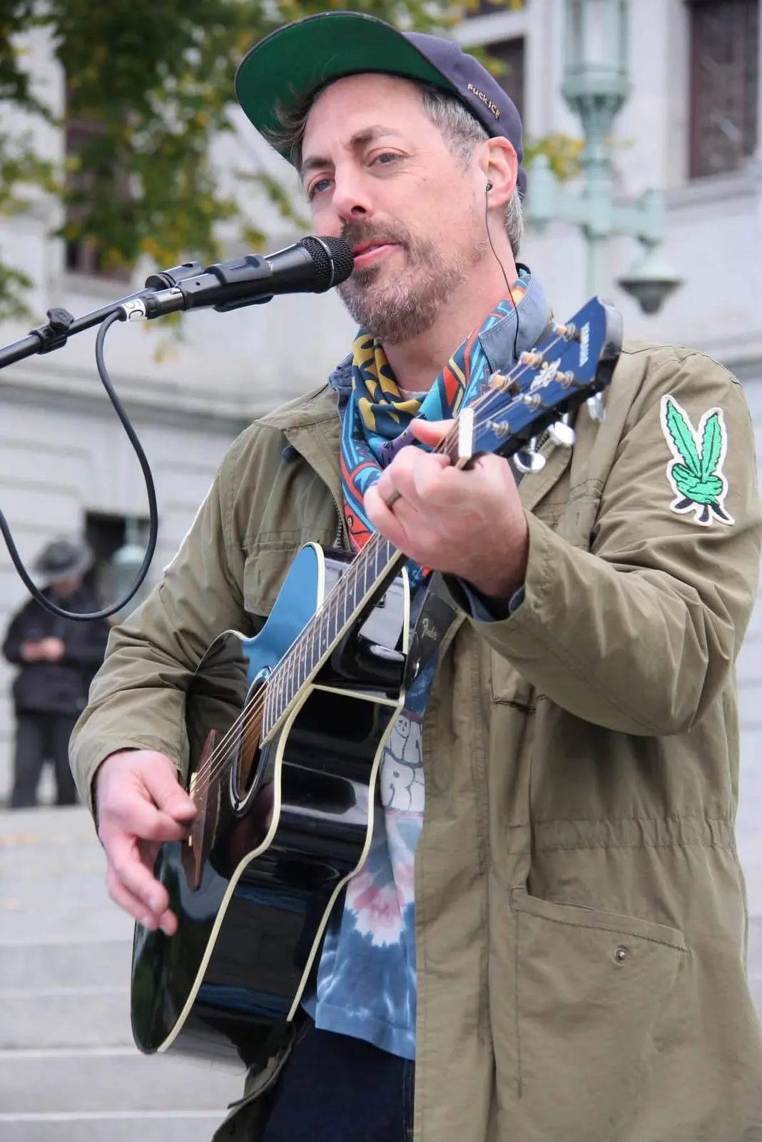 Close portrait of Rev. Haze performing with guitar